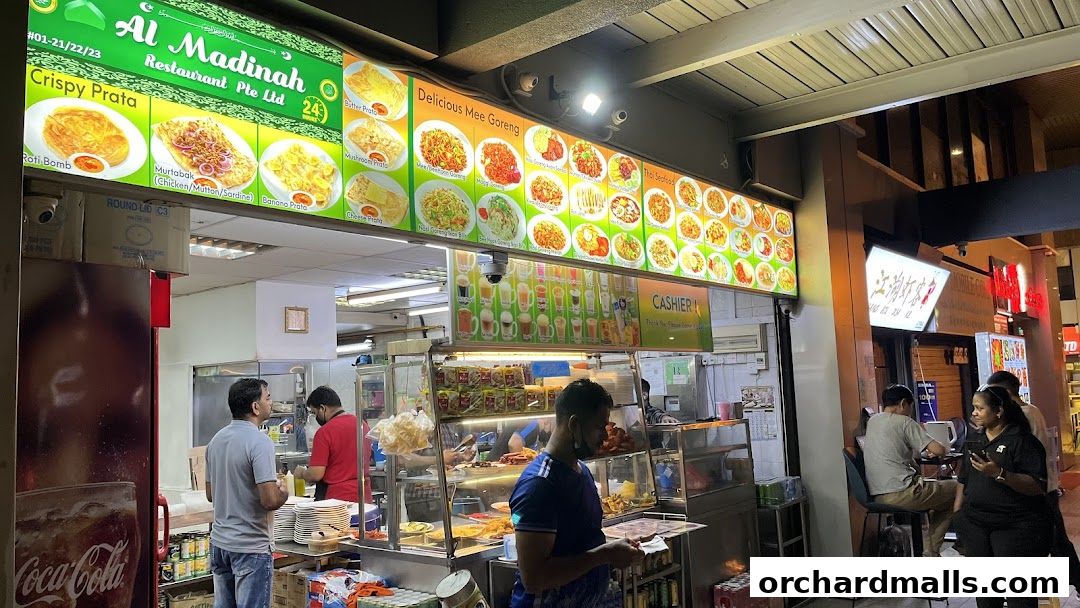 Al Madinah Restaurant exterior with a vibrant menu display and customers.