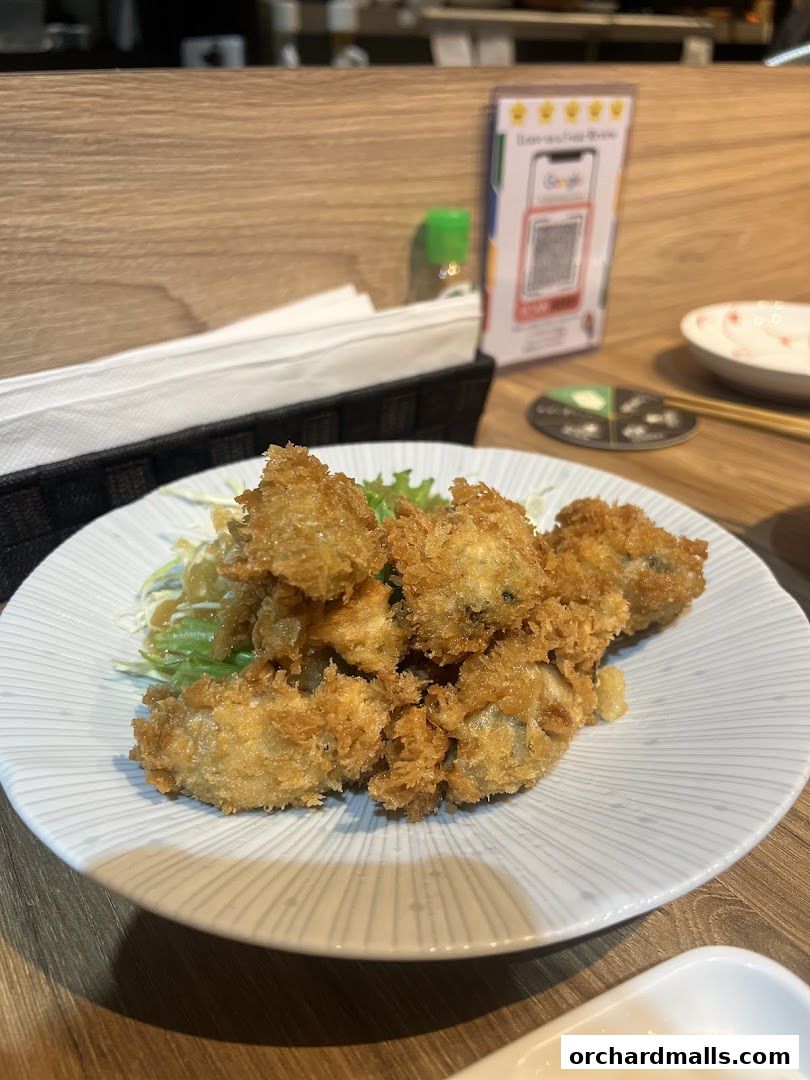 Crispy fried oysters served on a bed of shredded lettuce with a light dressing.