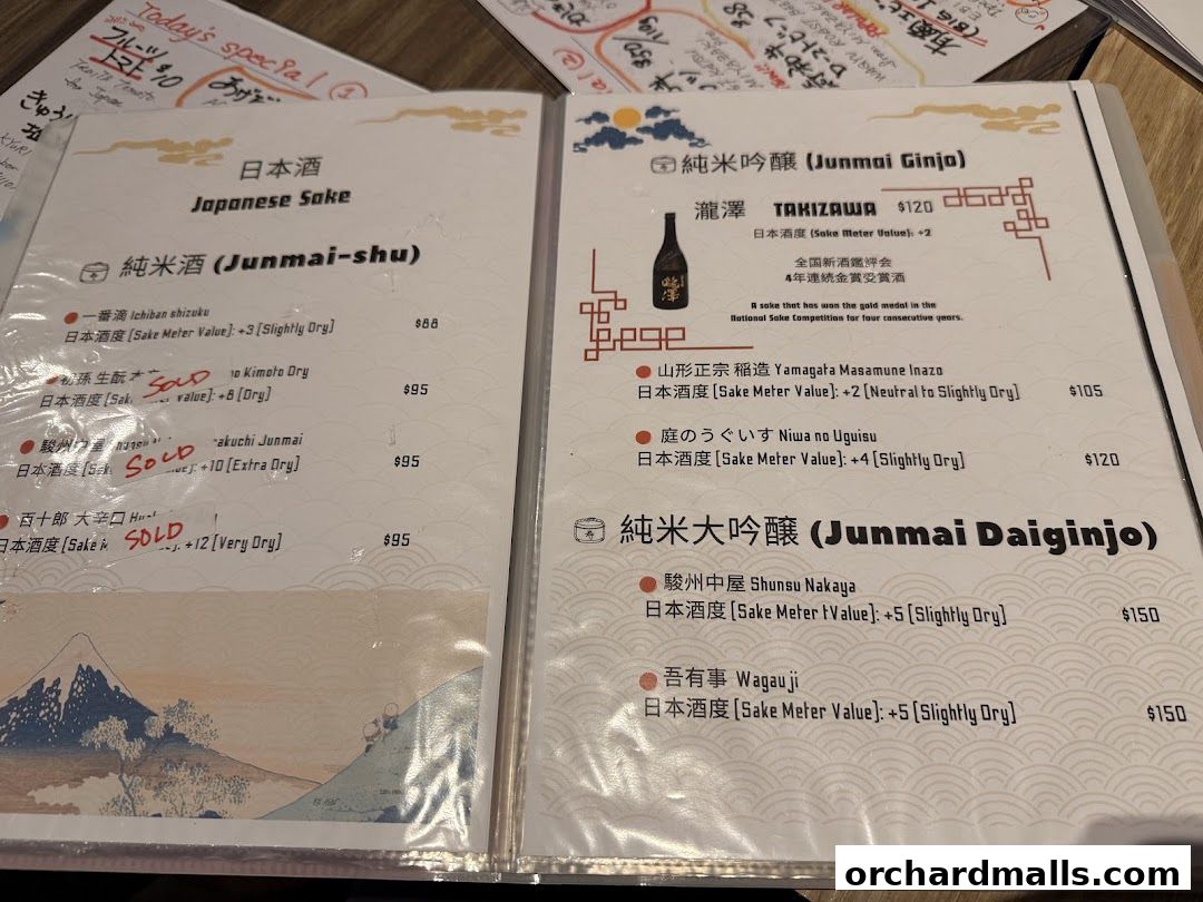 A menu featuring Japanese sake with categories like Junmai-shu, Junmai Ginjo, and Junmai Daiginjo.