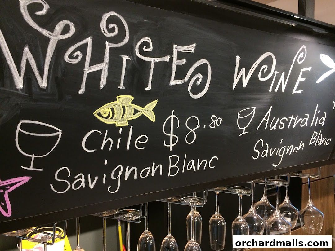 Chalkboard menu featuring white wines with prices and origins.