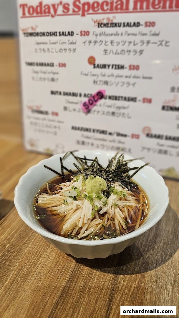 A close-up of a Japanese-Italian izakaya menu featuring today's specials and a dish.