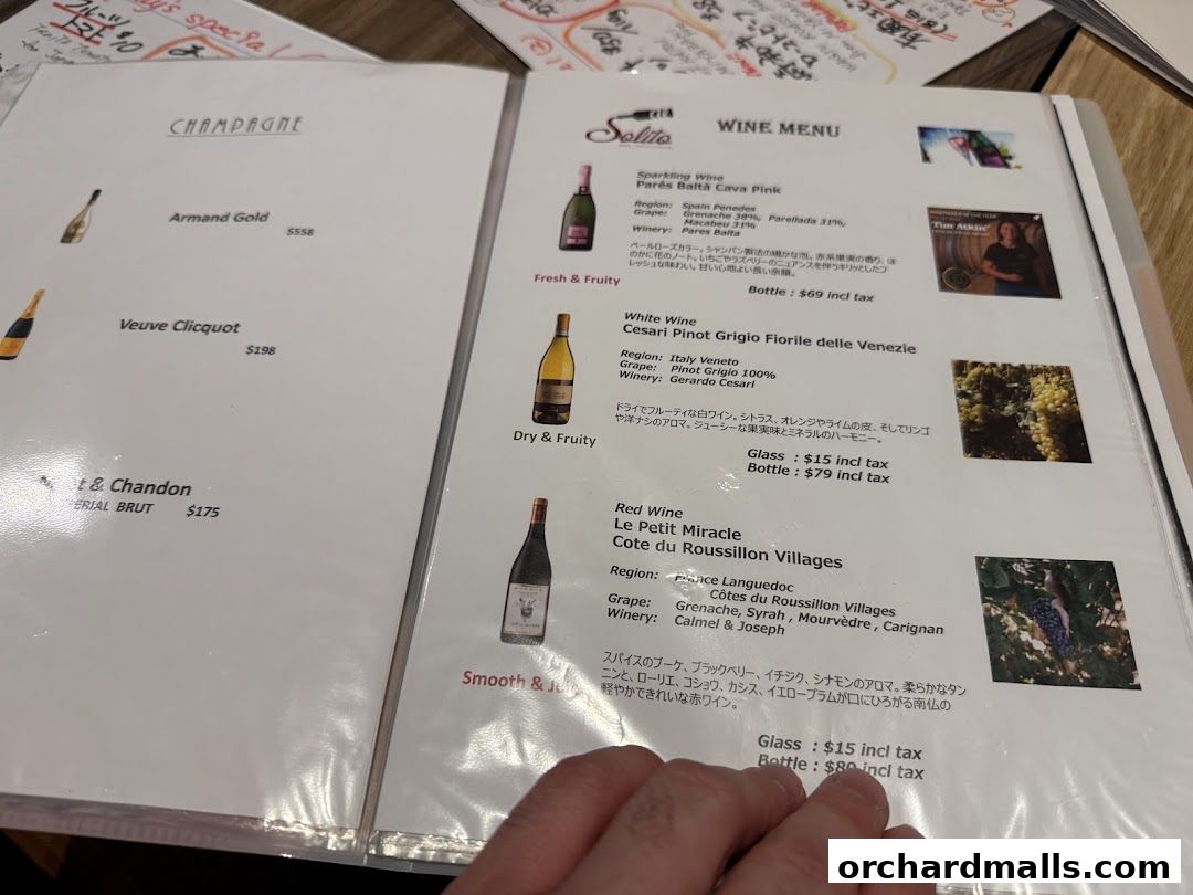 A menu featuring champagne, white wine, and red wine selections with prices.