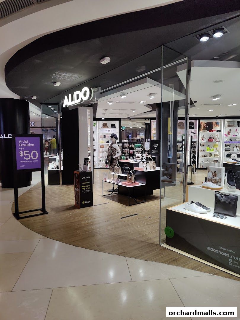 The entrance to an ALDO shoe store with displays of shoes and handbags.
