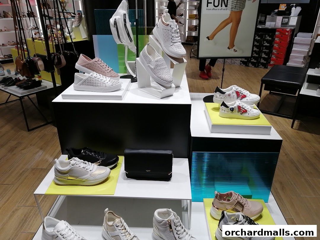 A display of stylish sneakers and handbags at a retail store.
