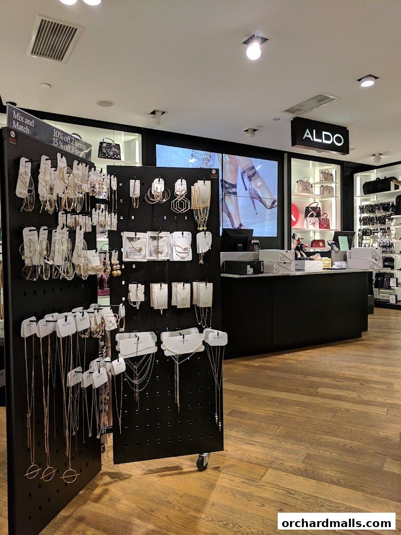 Interior view of an ALDO store showcasing necklaces, earrings, and handbags.