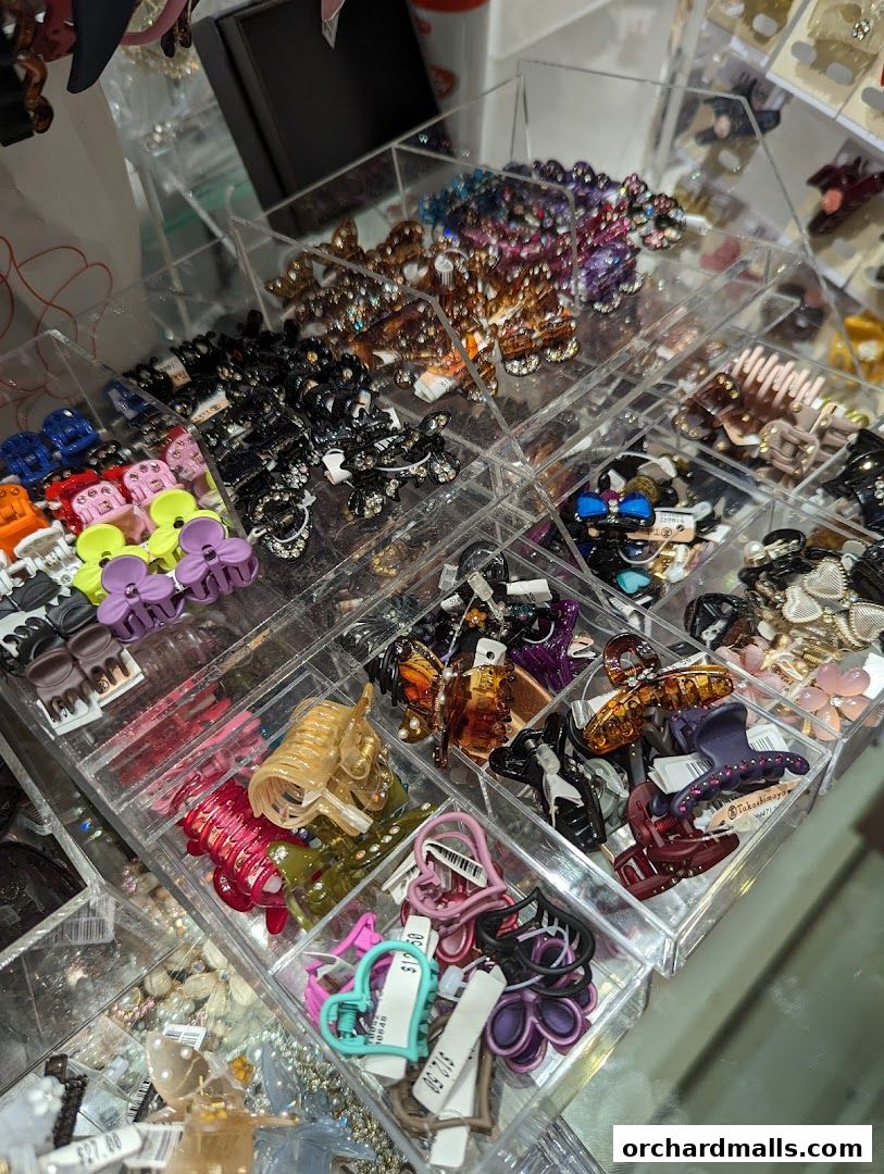 A display of colorful and sparkling hair clips and accessories in clear plastic compartments.