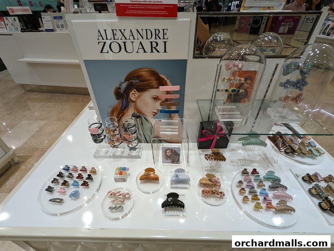 Display of Alexandre Zouari hair accessories, featuring various claw clips and barrettes.