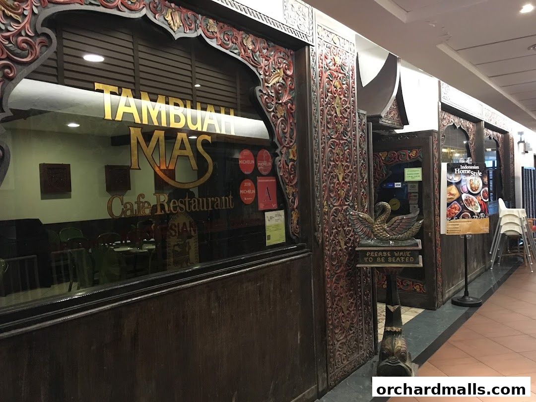 The exterior of Tambuah Mas, an Indonesian home-style cafe and restaurant, with ornate wooden carvings.