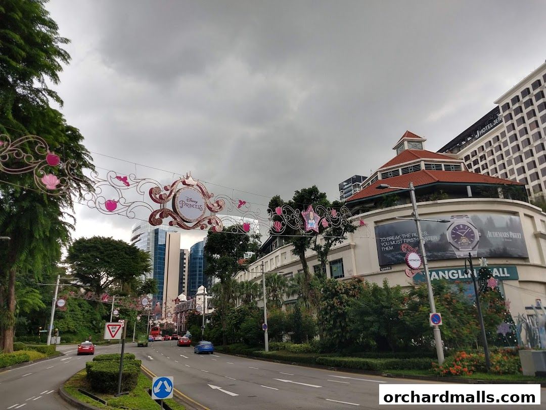 A street view of Tanglin Mall with Disney Princess decorations and an Audemars Piguet advertisement.