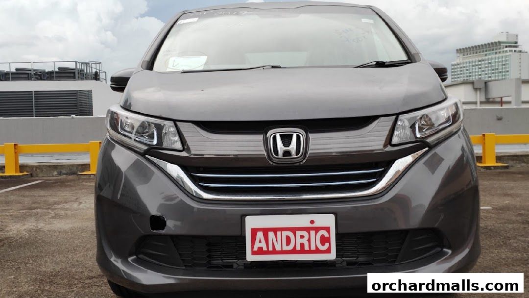 Front view of a grey Honda car with an 'ANDRIC' license plate.