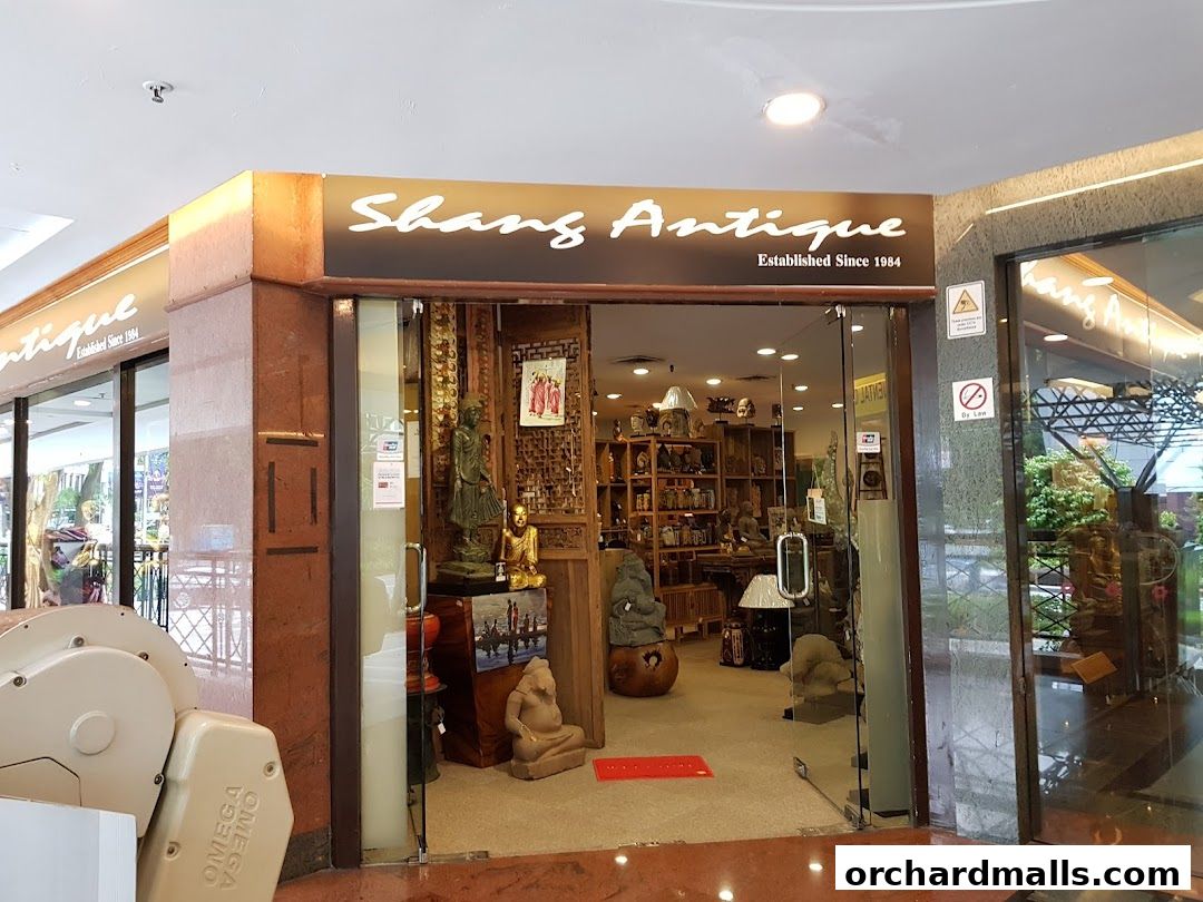The entrance of Shangs Antique shop, showcasing various antique statues and decor items.