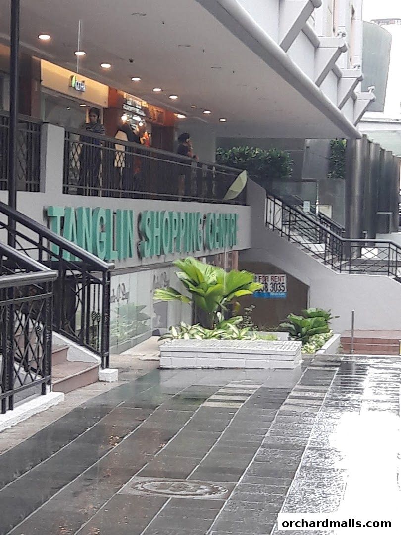 Exterior view of Tanglin Shopping Centre with people on the balcony and plants.