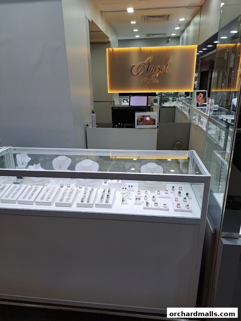 A jewelry store display case filled with rings, necklaces, and earrings.