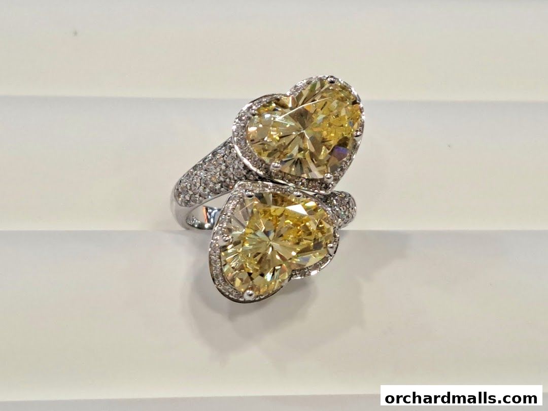 A stunning ring with two large yellow heart-shaped diamonds surrounded by smaller diamonds.