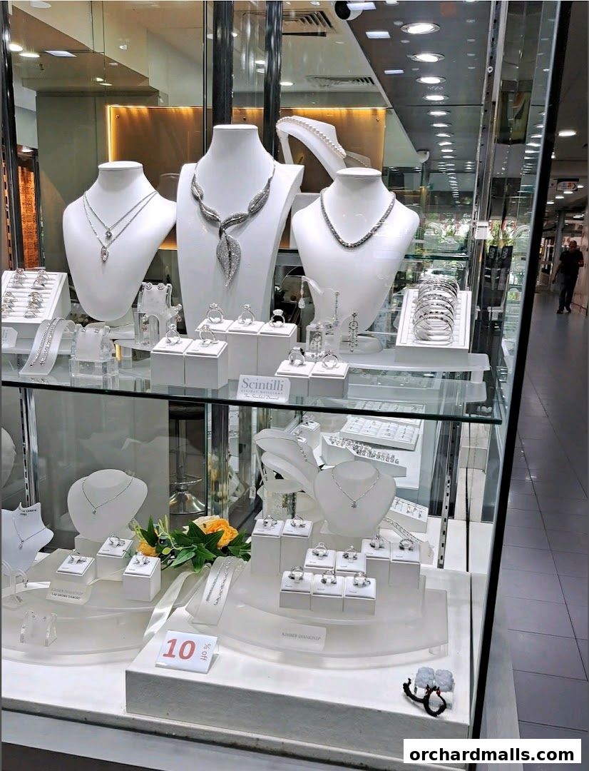 A jewelry store display case filled with necklaces, rings, and bracelets.
