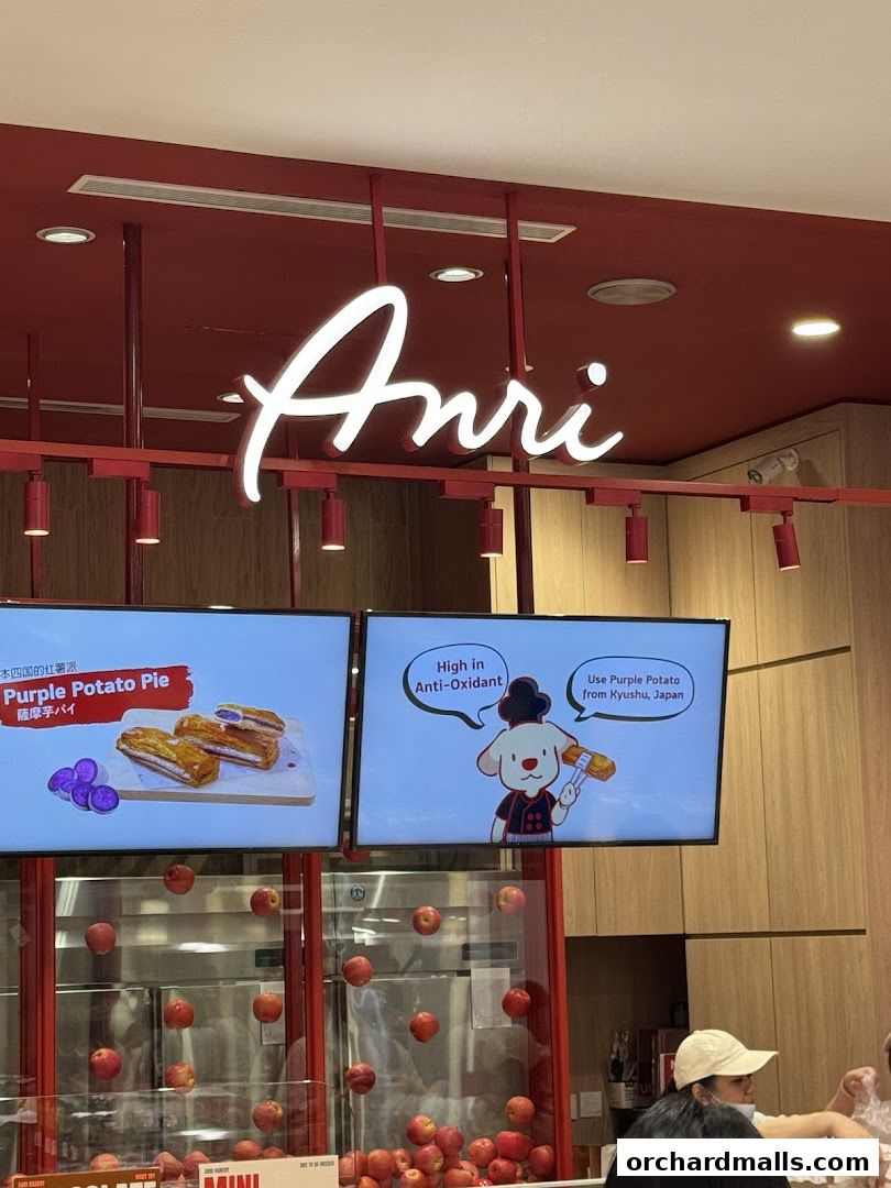 The Anri shop features a bright red interior with a neon sign and digital displays showcasing products.