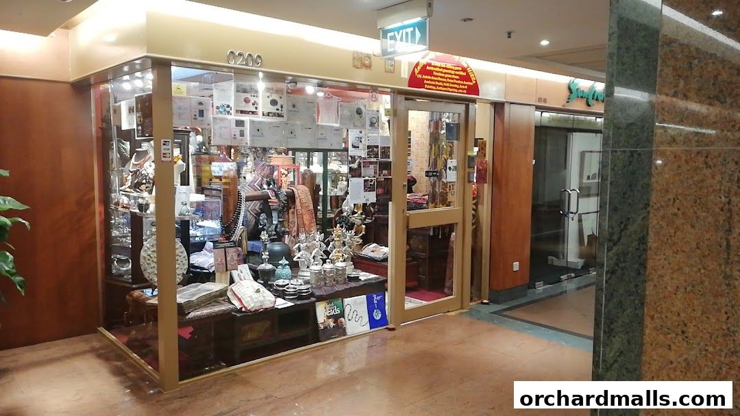 A shop displaying various antique items, jewelry, and decorative pieces in glass cabinets.