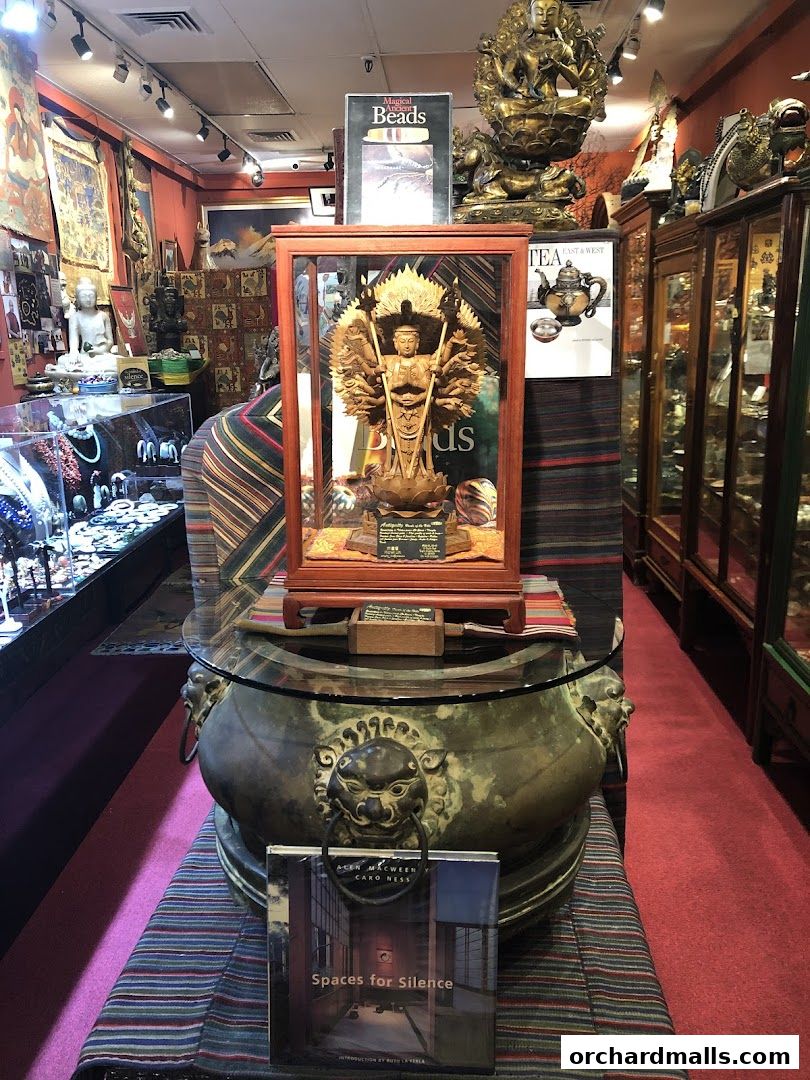 Interior of a shop filled with statues, artwork, and display cases of jewelry.
