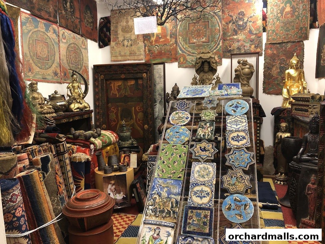 A shop filled with Tibetan thangkas, statues, carpets, and decorative tiles.