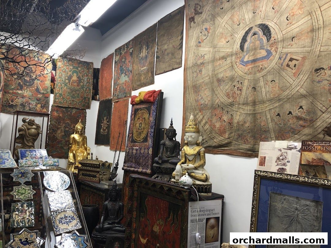 Interior of a shop filled with antique religious art, statues, and tapestries.