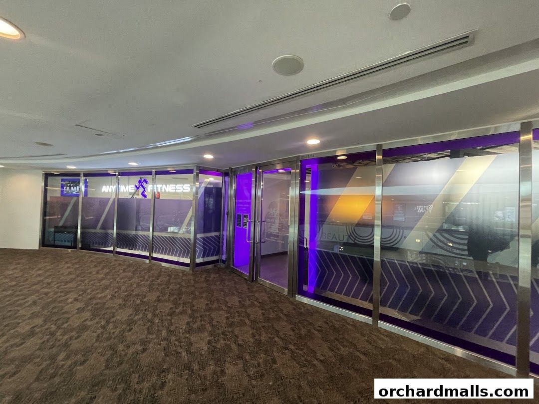 The modern entrance of Anytime Fitness Wheelock Place with purple accents and chevron patterns.