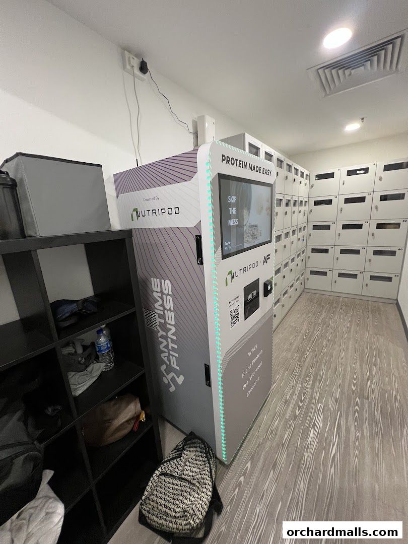 Interior shot of Anytime Fitness with a protein dispenser and lockers.