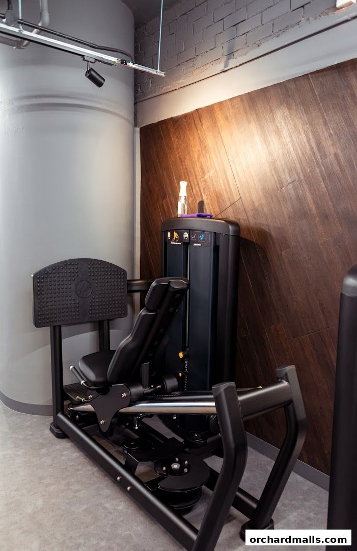 A leg press machine in a modern gym with wood-paneled walls.