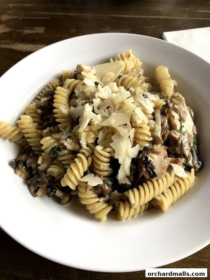 A close-up shot of a delicious pasta dish with mushrooms and cheese.