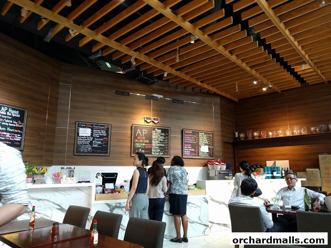 Interior of AP House restaurant with wooden ceiling, marble counter, and patrons dining.