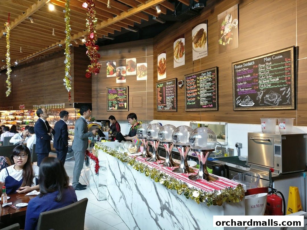 Interior of AP House cafe with a marble counter, beverage dispensers, and menus on the wall.