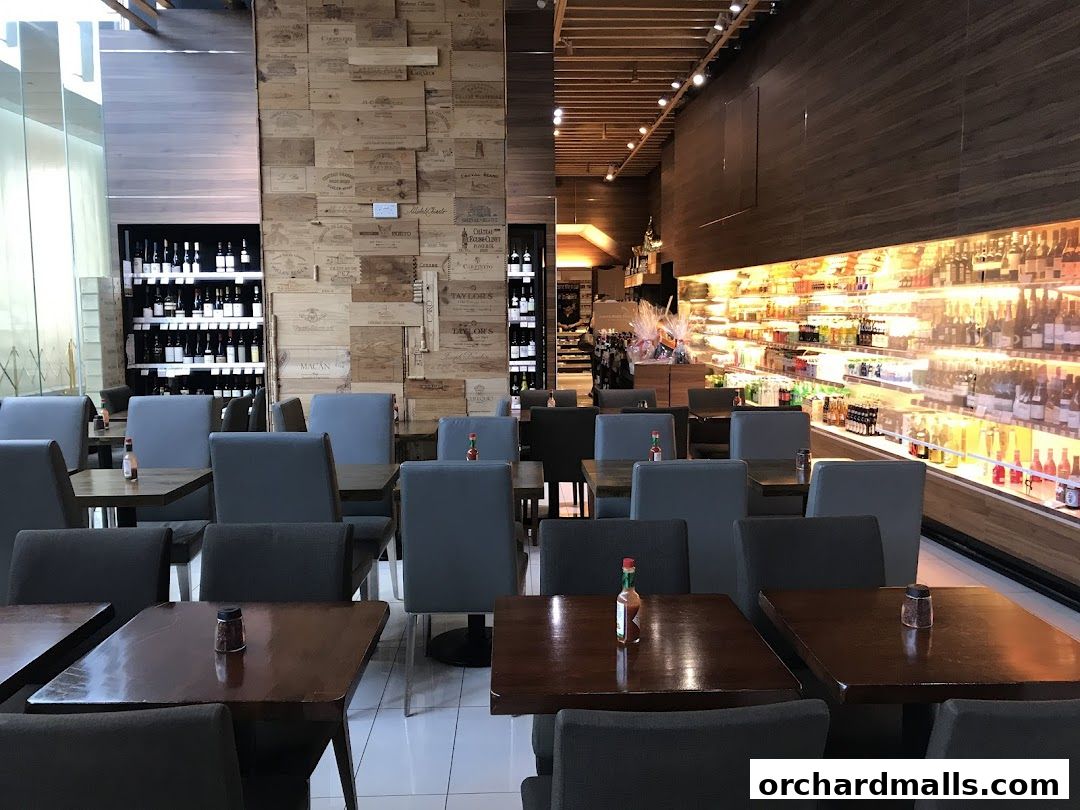 Interior of AP House with dining tables and a well-stocked beverage display.