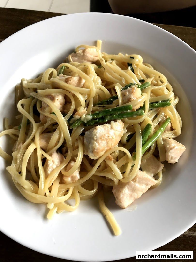 A close-up shot of a delicious pasta dish with chicken and asparagus.