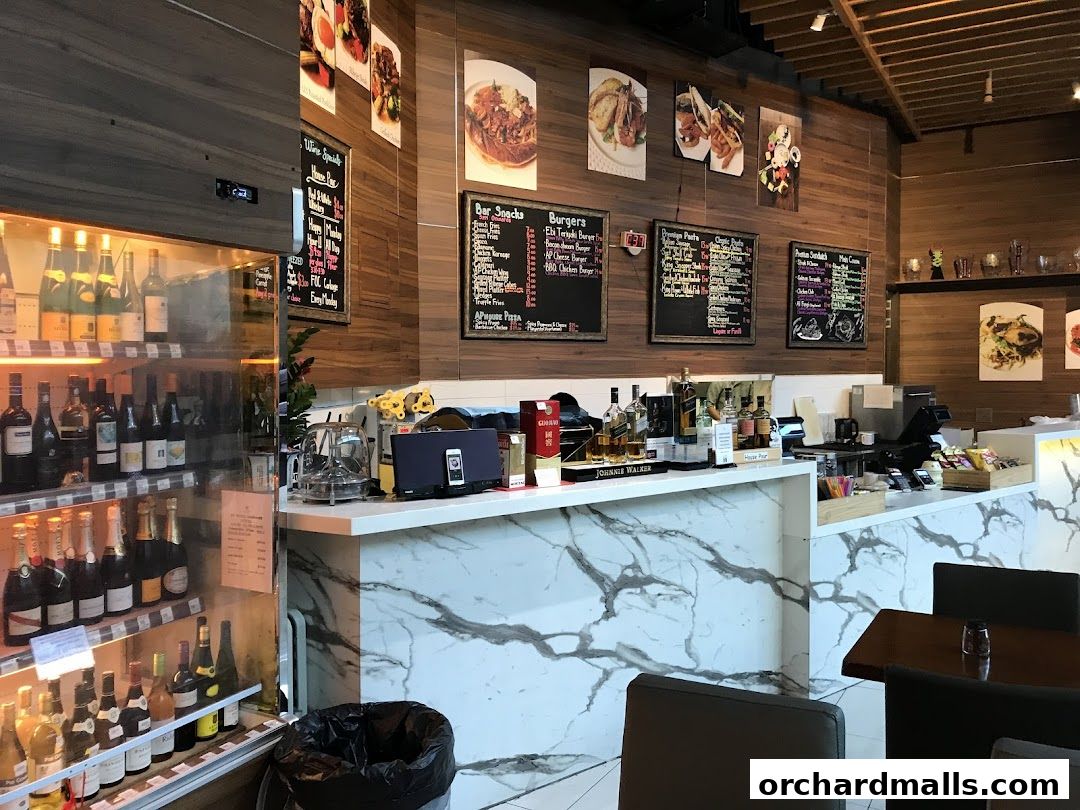 Interior view of AP House restaurant with a bar, wine display, and menus on the wall.