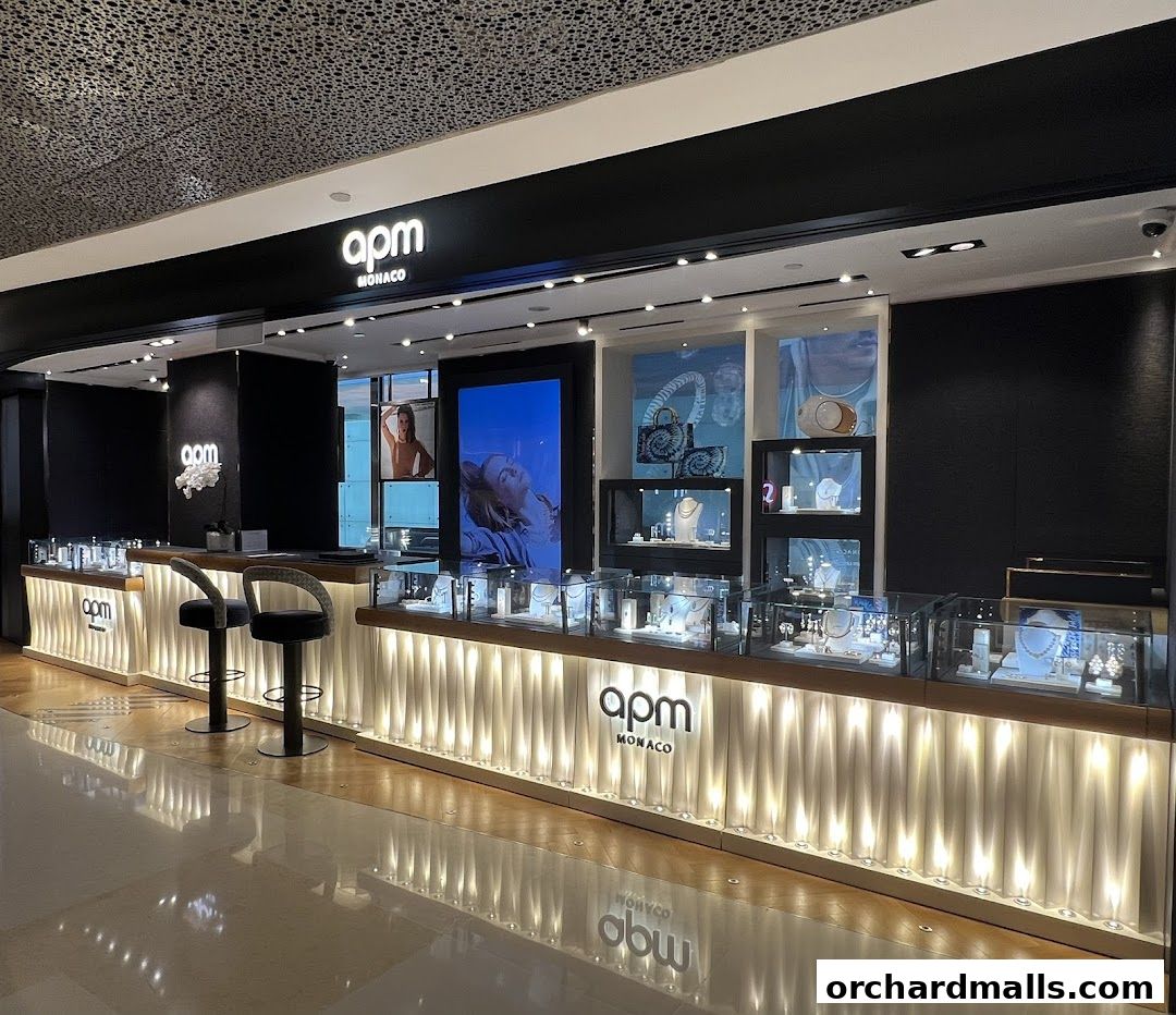 The APM Monaco Singapore ION Orchard shop front displays jewelry in illuminated display cases.