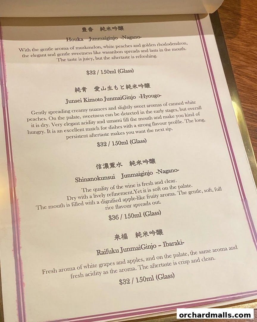 A menu page from Apollon featuring various Junmai Ginjo sakes with descriptions and prices.