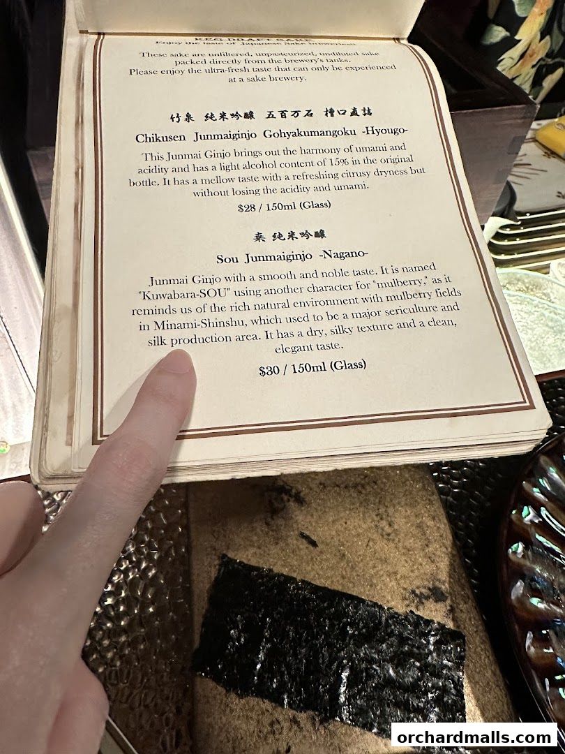 A menu page detailing two types of Junmai Ginjo sake with descriptions and prices.