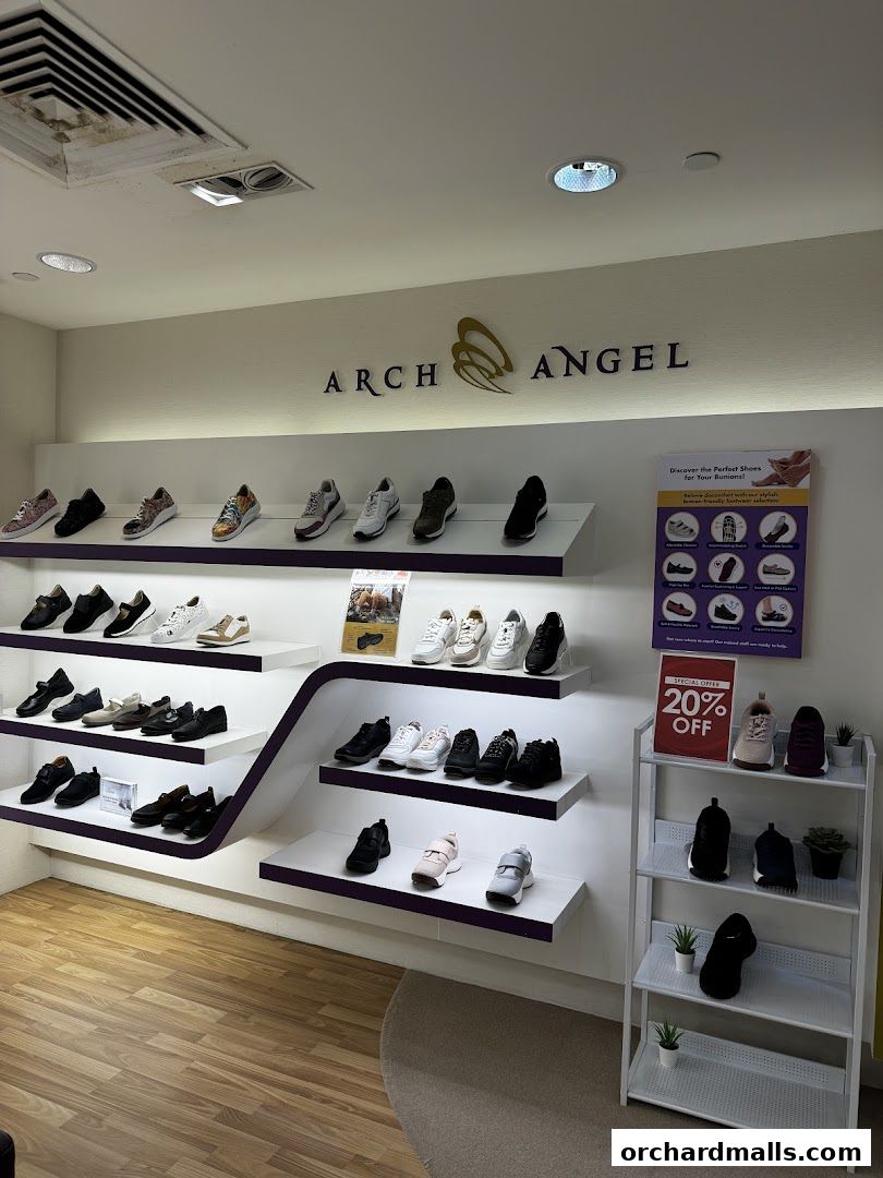Interior view of Arch Angel Shoes store showcasing various footwear on display shelves.