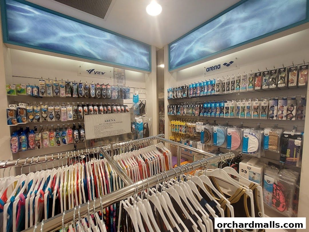 Interior view of Arena Swimwear Takashimaya, showcasing swimwear, goggles, and accessories on display.