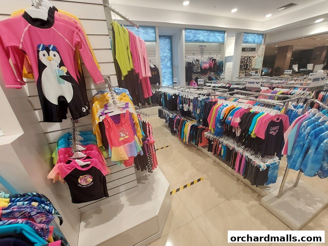 Interior view of Arena Swimwear Takashimaya, showcasing a wide selection of colorful children's swimwear.