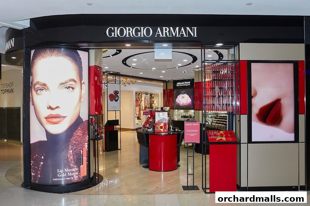 The entrance of a Giorgio Armani beauty store, featuring large advertisements and displays of makeup products.
