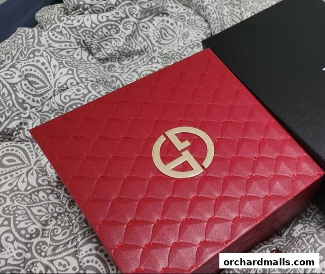 A red quilted box with the Armani logo sits next to a black box.