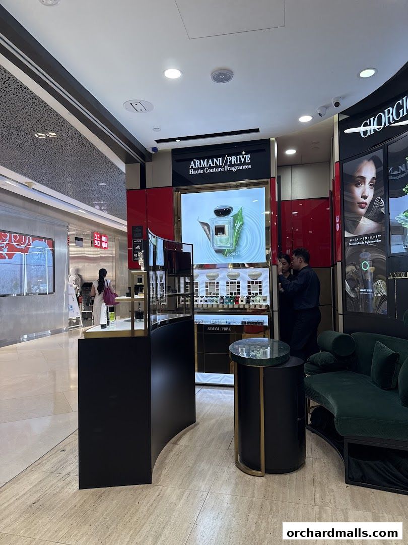 Interior view of an Armani beauty store featuring fragrances and makeup displays.