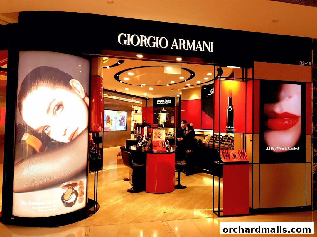 The Giorgio Armani beauty store entrance features large displays of makeup and models.