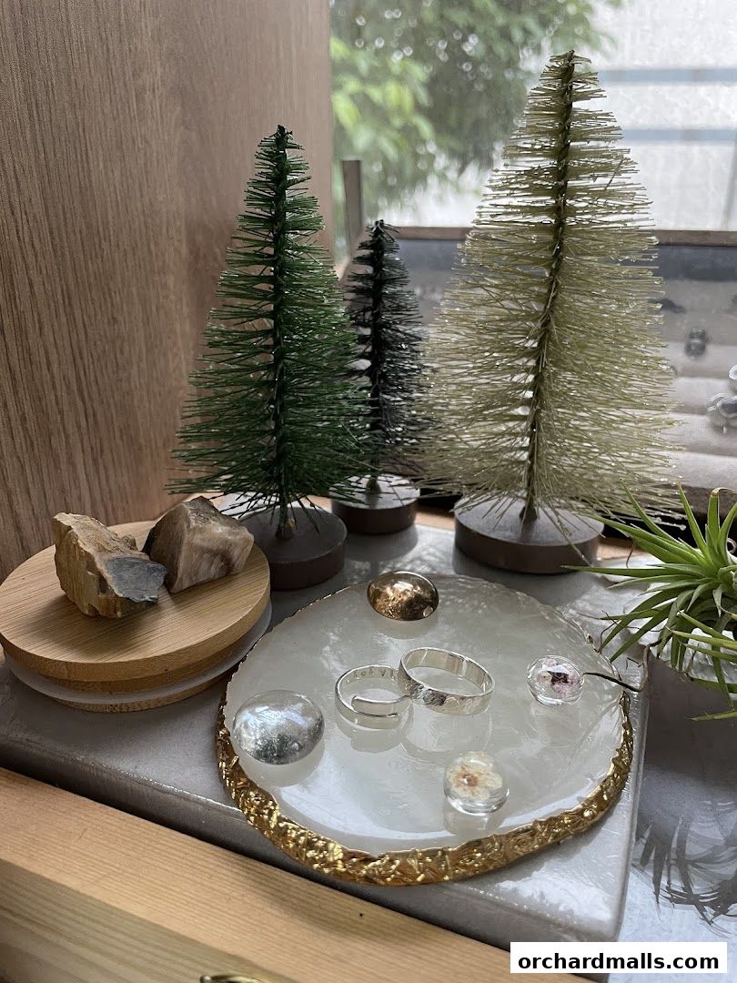 Artisan jewelry displayed with decorative trees and natural elements.