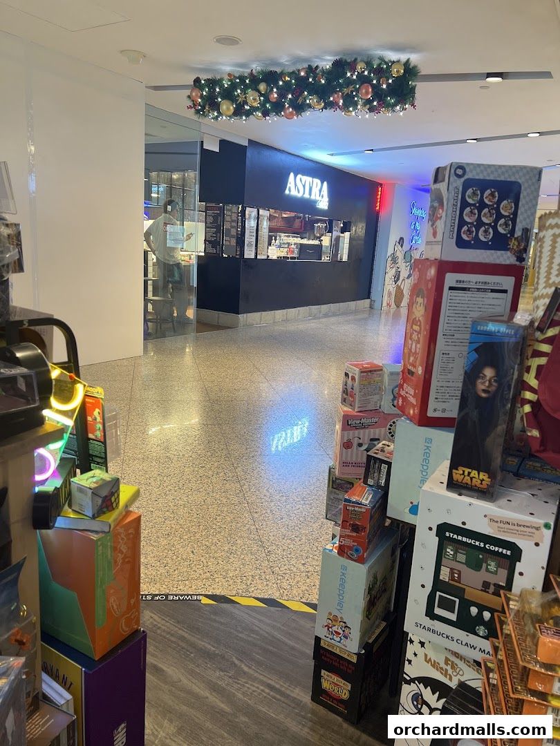 The ASTRA Deli 星辰咖啡 shop front with festive decorations and merchandise displays.