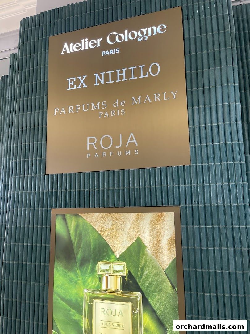 A sign displays luxury perfume brands Atelier Cologne, Ex Nihilo, Parfums De Marly, and Roja.