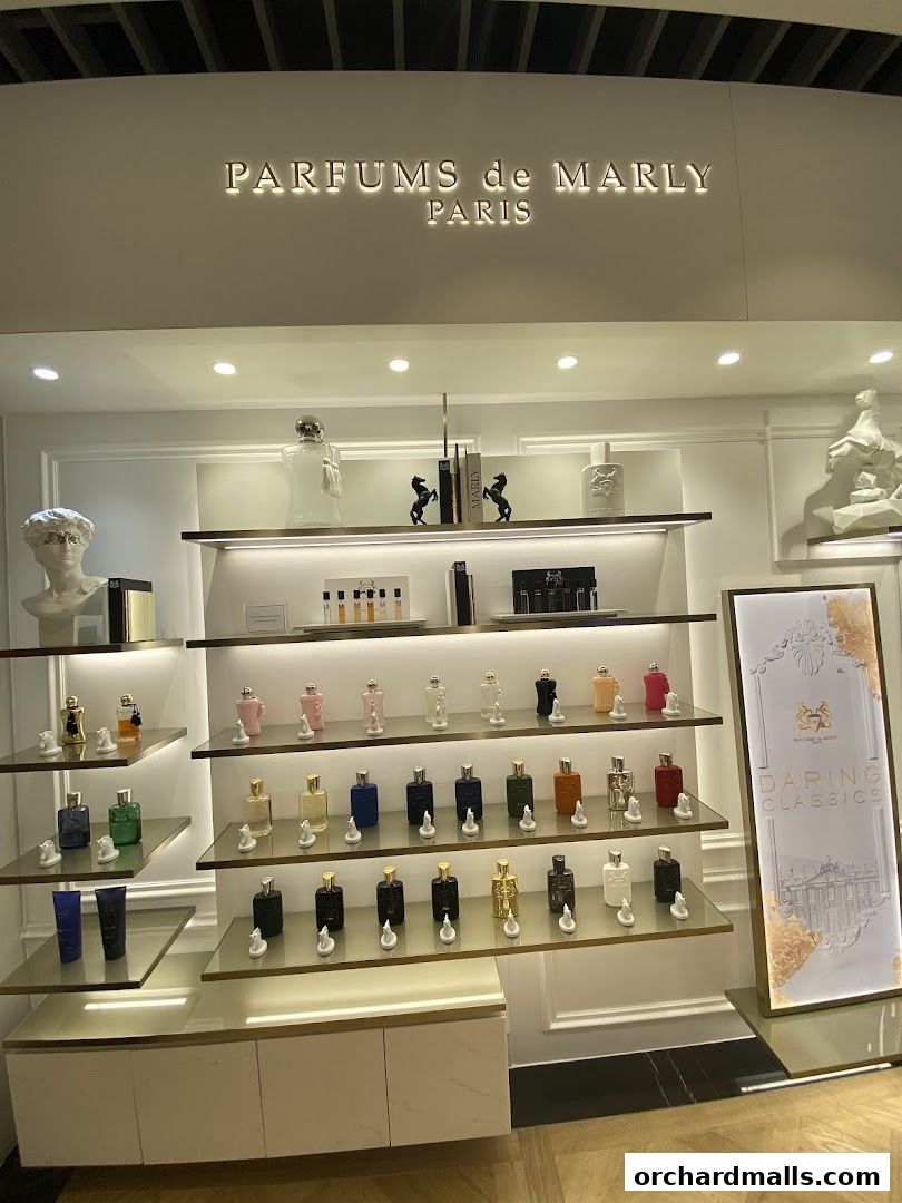 A display of various perfumes from Parfums de Marly Paris, with decorative elements.