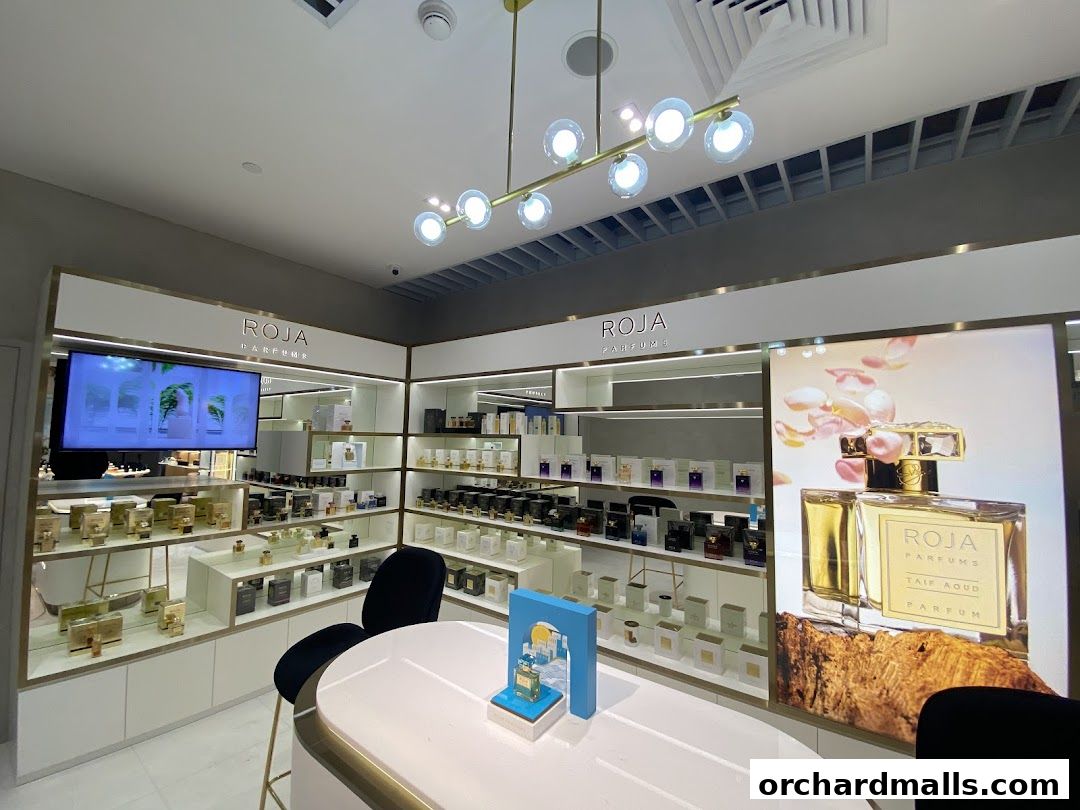 Interior view of a luxury perfume shop showcasing various fragrances and displays.
