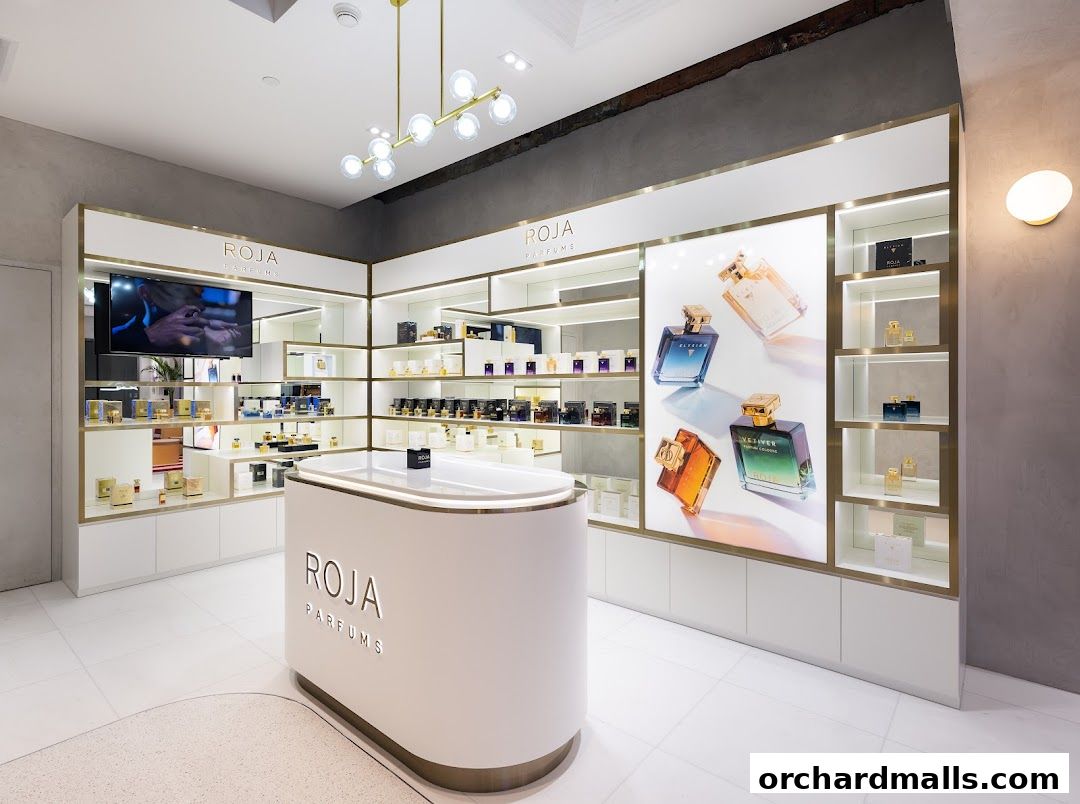 Interior of a luxury perfume shop showcasing various fragrances on shelves and a central display.