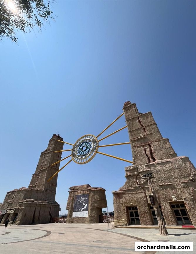 A striking architectural landmark with a large clock face against a clear blue sky.